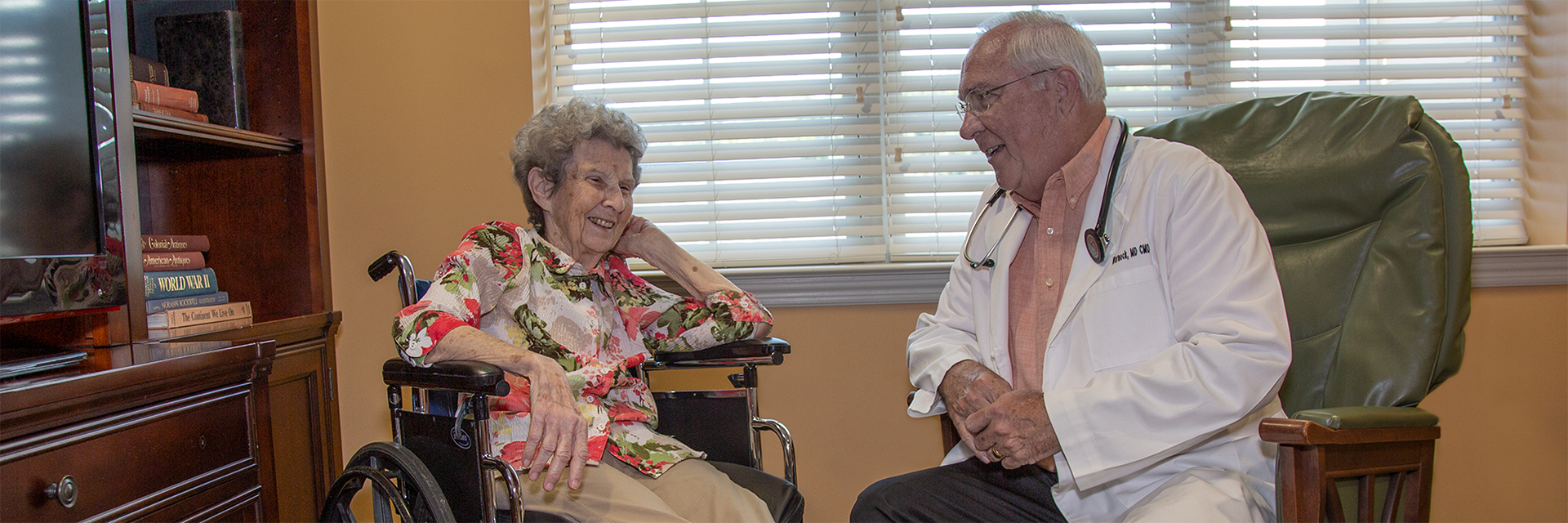 Ga Med Group associate smiling and talking with a patient